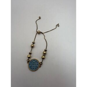 Gold Tone Adjustable Bracelet with Blue Cutout Oval Medallion & Bead Accents